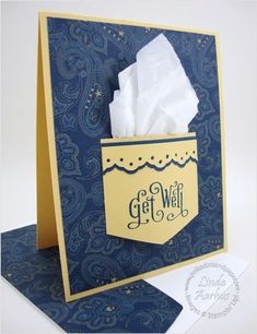 a blue and yellow greeting card with tissue in a pocket that says get well on it