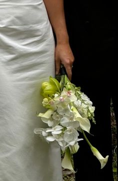 the bride and groom are holding their bouquets