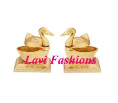 two golden ducks sitting on top of each other in front of the words law fashions