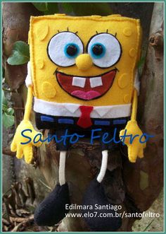 a spongebob stuffed animal hanging on a tree branch with the caption sanito feliro