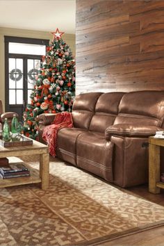 a living room filled with furniture and a christmas tree