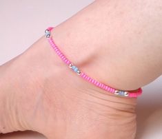 "Bright, bold and beautiful! This neon pink and blue beaded anklet is crying out to be worn for care free days in the sun. To create this summery anklet I've combined neon pink seed beads with shiny silver plated and matte blue beads.  With a hint of an Aztec feel to it, this ankle bracelet is bound to make you smile! This beaded anklet measures approximately 9.75\" long and fastens with a silver plated bolt clasp.  I am more than happy to provide custom-length anklets but please do get in touch Colorful Beaded Anklets For Spring Gift, Pink Trendy Anklets For The Beach, Spring Gift Anklets With Colorful Beads, Trendy Pink Beach Anklets, Pink Trendy Beach Anklets, Pink Beaded Bracelets For Spring Festival, Bohemian Pink Anklets With Round Beads, Pink Beaded Bohemian Anklets, Pink Bohemian Beaded Anklets