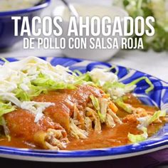 tacos ahogados de pollo con salsa rojaa on a blue and white plate