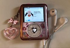 an mp3 player and earphones are laying on the table