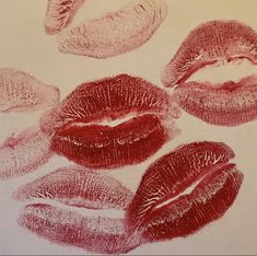 four different lipsticks are shown in red and pink ink on a white paper background