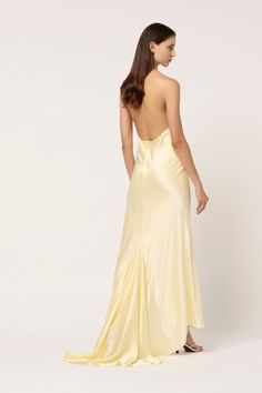 the back of a woman wearing a yellow dress