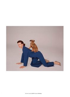 a woman is sitting on the floor with her dog in her lap and looking up