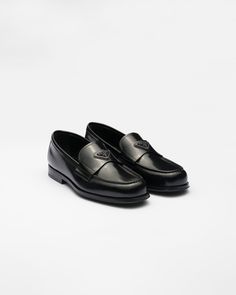 Band with enameled metal triangle logo Leather sole with rubber half-sole and heel layer with hot-stamped logo 25 mm heel Mens Prada Loafers, Prada Loafers Men, Prada Shoes Men, Mens Black Loafers, Black Loafers Men, Designer Shoes Men, Prada Mens, Shoes Png, Black Moccasins