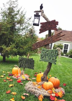 a yard decorated for halloween with pumpkins and hay