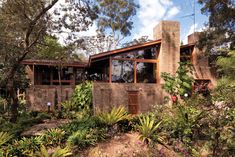 the house is surrounded by trees and plants