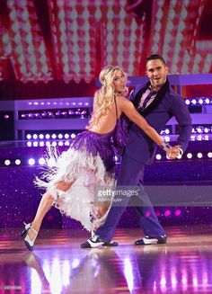 a man and woman dancing on the dance floor