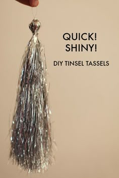 a hand holding a tiny silver tassel with the words quick shiny diy tinsel tassels