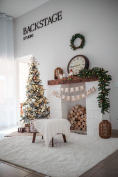 a living room with a christmas tree and fireplace