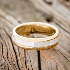 a wedding ring sitting on top of a wooden table