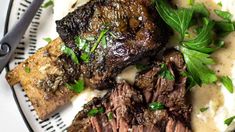 steak, mashed potatoes and parsley on a white plate with gravy