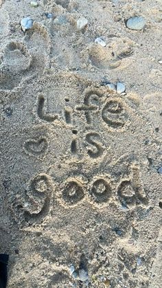 the words life is good written in the sand