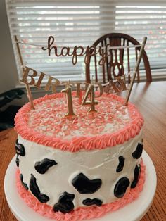 a birthday cake with pink and black frosting