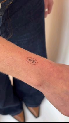 a person with a small tattoo on their arm