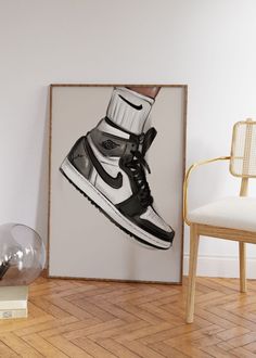 a black and white nike sneaker poster hanging on a wall