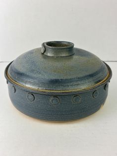 a blue pot sitting on top of a white table