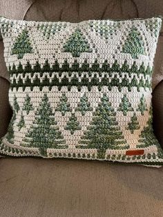 a green and white pillow sitting on top of a couch