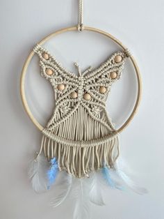 a white and blue dream catcher hanging on a wall