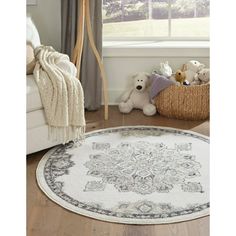 a large white rug with an ornate design on the floor in front of a window