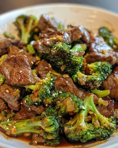 beef and broccoli stir fry on a white plate