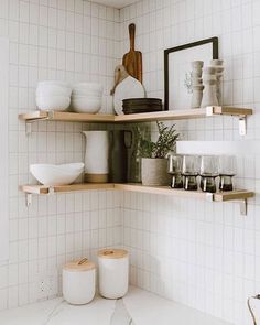 the shelves in the kitchen are filled with dishes