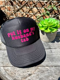 This black trucker hat reads "Put It On My Husband's Tab" and is perfect for any fun-loving and confident individual. Made with high-quality materials, this hat is both comfortable and stylish. Show off your playful side and let everyone know who's really in charge. Made for those who want to make a statement and look good doing it. Black Snapback Hat With Letter Print, Novelty Black Trucker Hat With Curved Brim, Black Novelty Trucker Hat With Curved Brim, Fun Black Trucker Hat With Letter Print, Novelty Black Trucker Hat With Letter Print, Novelty Black Trucker Hat One Size, Black Novelty Trucker Hat One Size, Novelty Black Hat With Letter Print, Black Novelty Trucker Hat