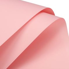 a close up view of a pink sheet of paper that has been folded in half