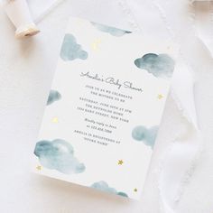 a baby shower card with clouds and stars on it