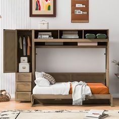 a bunk bed with a desk underneath it in a room that has white walls and wood floors