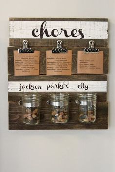 three mason jars are hanging on a wall with labels and magnets attached to them