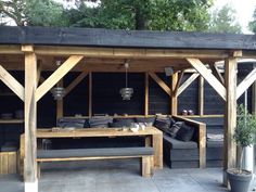 an outdoor living area with couches and tables