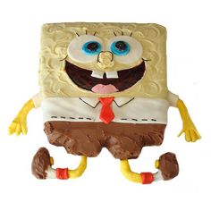 a cake that looks like spongebob is wearing a tie and pants with blue eyes