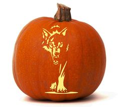 a carved pumpkin with an image of a wolf on it