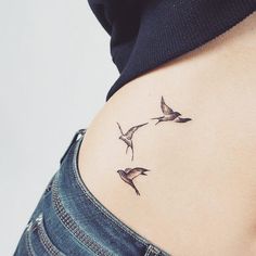 three birds flying in the air on top of a woman's side ribcage