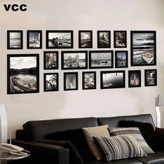 a living room filled with black and white pictures on the wall above a leather couch