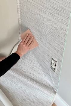 a person is cleaning the wall with a cloth