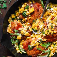 a skillet filled with chicken, corn and cilantro