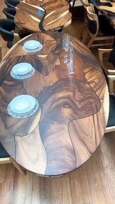 the table is made out of wood and has an artistic design on it's surface