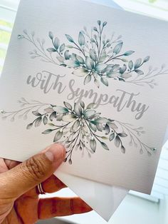 someone holding up a card with the word sympathy on it