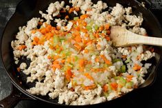 a skillet with cauliflower, carrots and celery