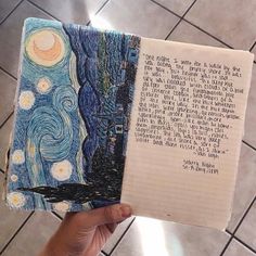 someone is holding up a notebook with an image of the starry night on it