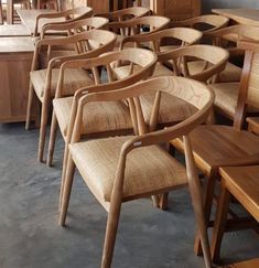 a row of wooden chairs sitting next to each other