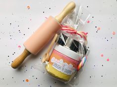 a doughnut and rolling pin on a table with confetti sprinkles