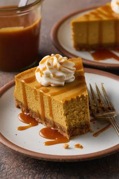 a slice of pumpkin cheesecake with whipped cream on top and caramel drizzle