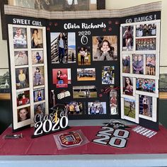 a table topped with pictures and photos next to a sign