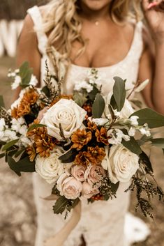 a woman holding a bouquet of flowers in her hands